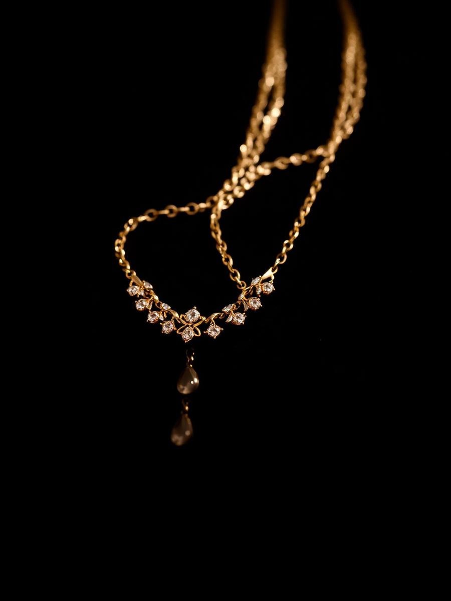 Gold diamond necklace draped on black velvet